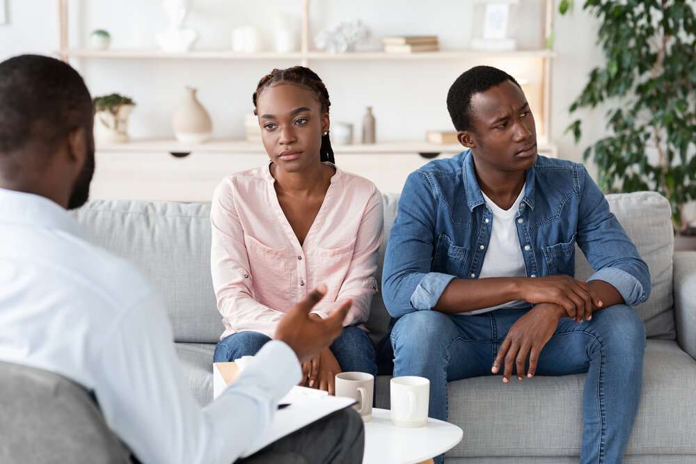 The Love Central - Couples Therapy Depressed African Spouses Sitting On Couch At Counselors Office The Love Central -