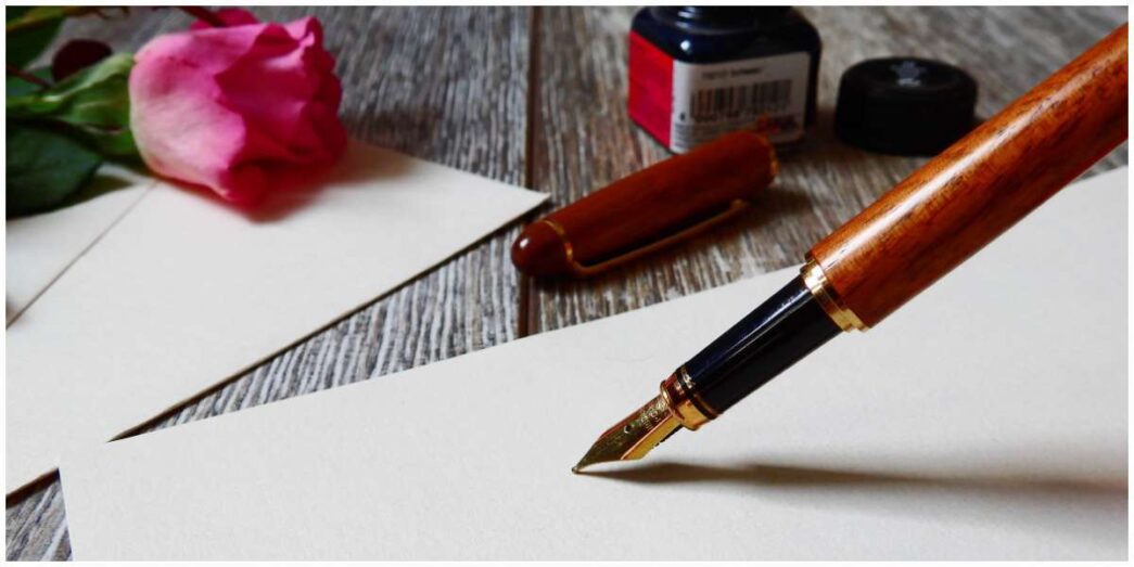 The Love Central - Photo of a pen and paper for letter writing