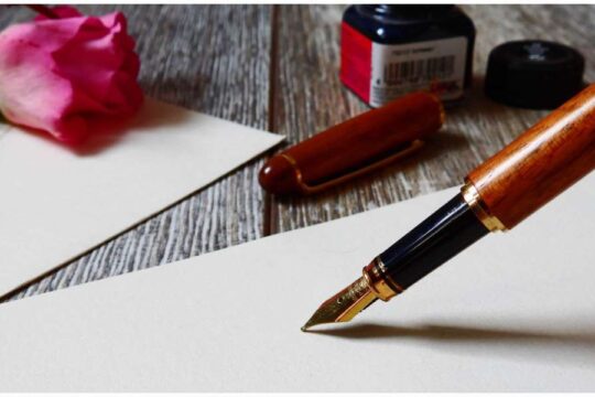 Photo of a pen and paper for letter writing