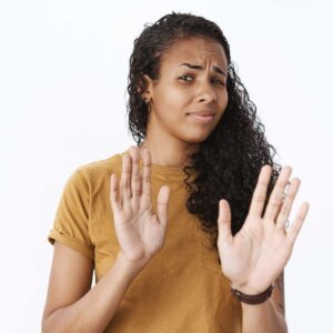 The Love Central - Close-up shot of disappointed and uninterested african-american female customer frowning from disgust and dislike and shaking head in no gesture rasing palms as refusing, giving rejection The Love Central - 5 Ways to Say No to Your Friends and Still Keep Them