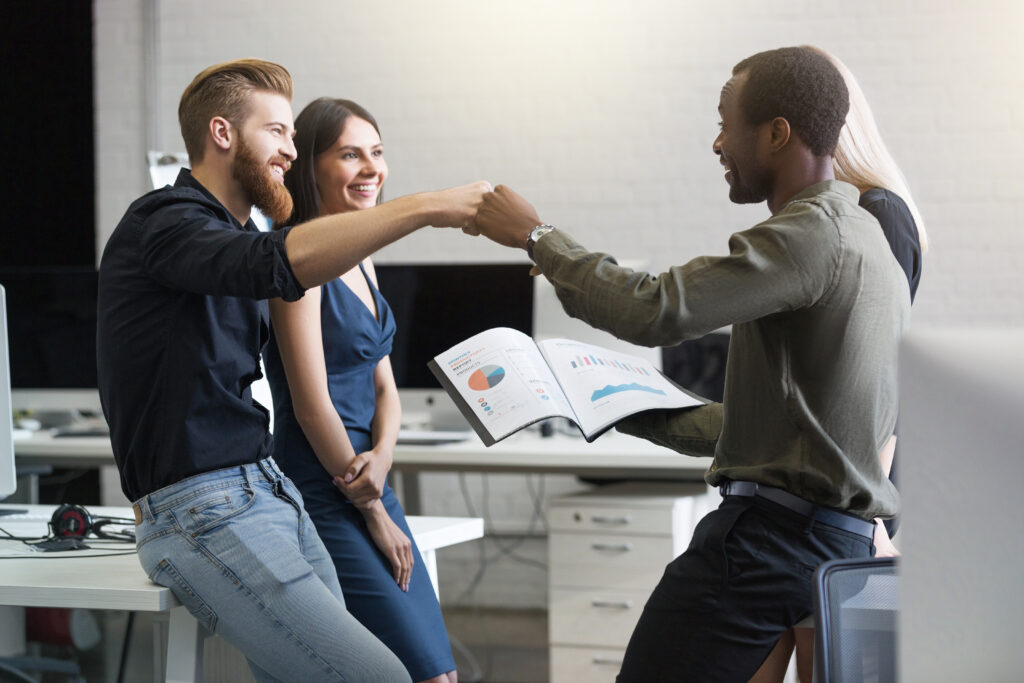 The Love Central - Group of happy young business people celebrating success When you smile genuinely and often, it shows that you're approachable and open to hearing what your team has to say