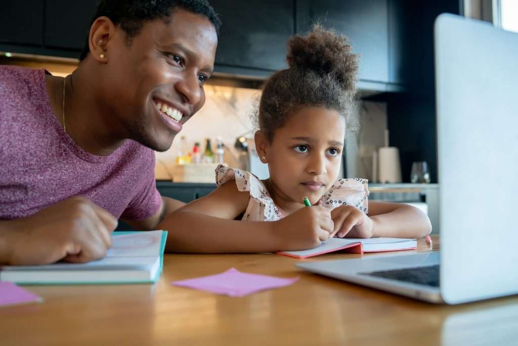 The Love Central - A father helping his daughter with homeschool The Love Central -