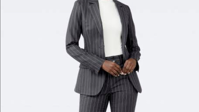 Pinstripe power dressing, a style often associated with men, is now making its way into the wardrobes of women in the workplace.
