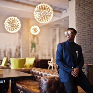 The Love Central - Fashionable african american man in suit and glasses posed at ca The Love Central - ive Like a King (or Queen) Without Breaking the Bank