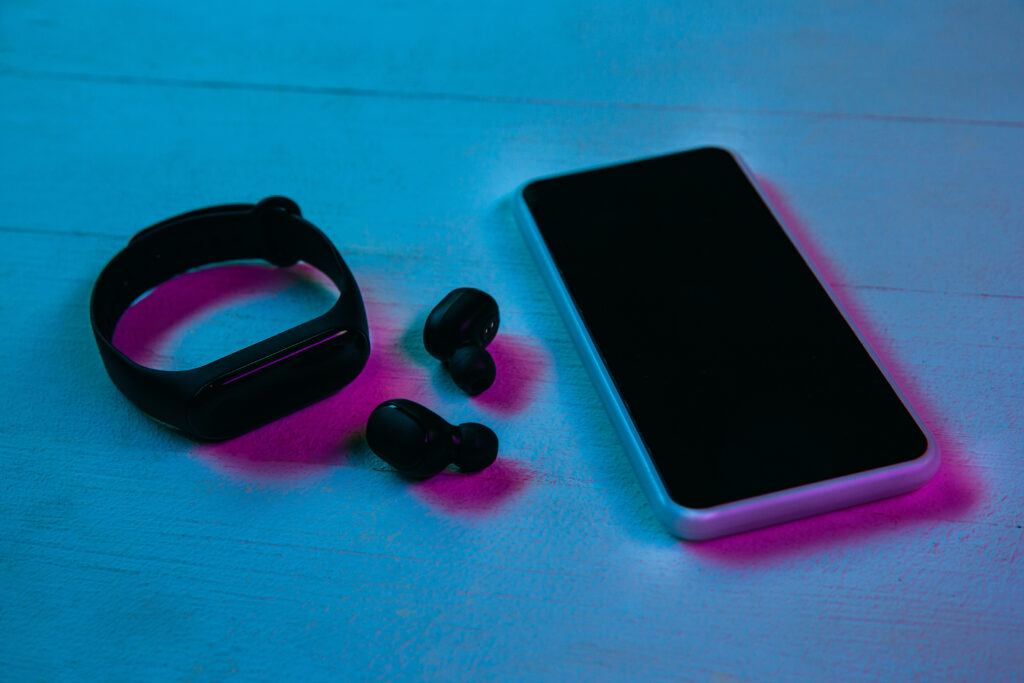 The Love Central - Top view of set of gadgets in purple neon light The Love Central -