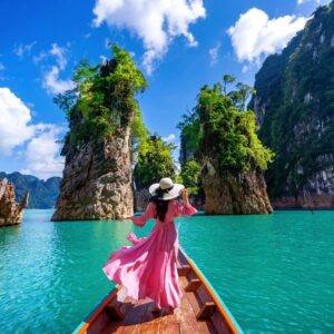 The Love Central - Beautiful girl standing on the boat and looking to mountains in The Love Central - November's Cultural Delights: Top Travel Destinations for a Rich Experience