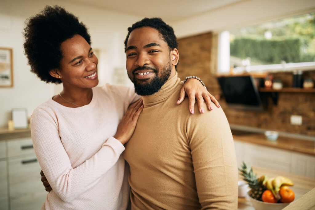The Love Central - Happy African American man and his wife at home. The Love Central -