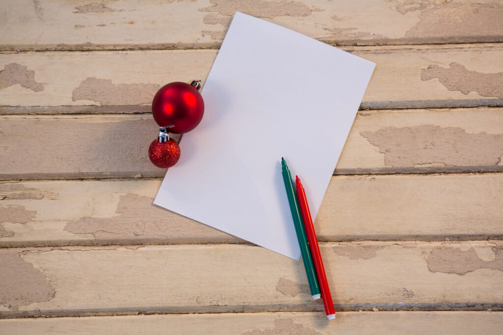 The Love Central - Christmas bauble ball felt pen and paper on wooden plank The Love Central -