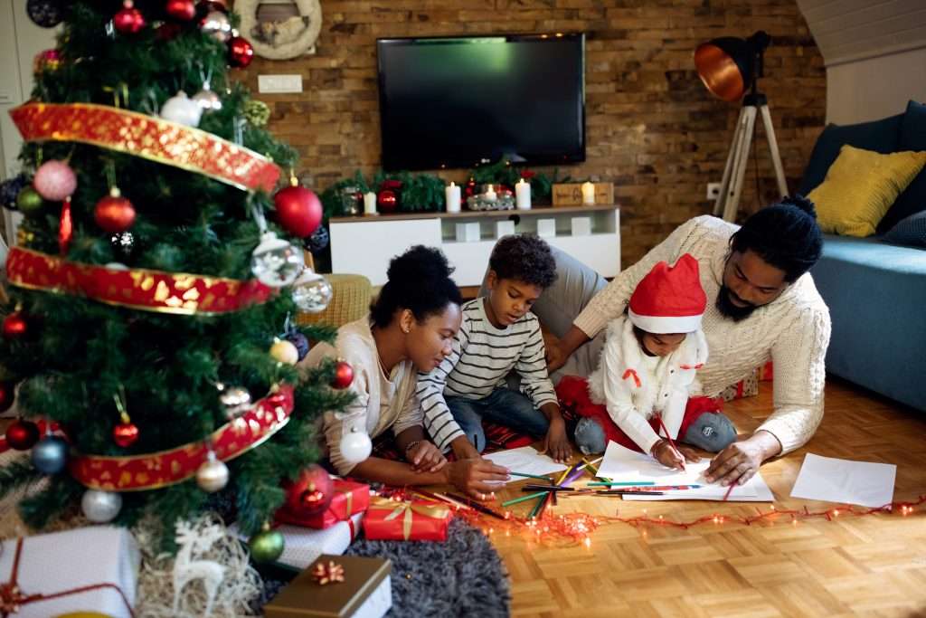 The Love Central - Creative black family coloring on the paper while spending Chris The Love Central -