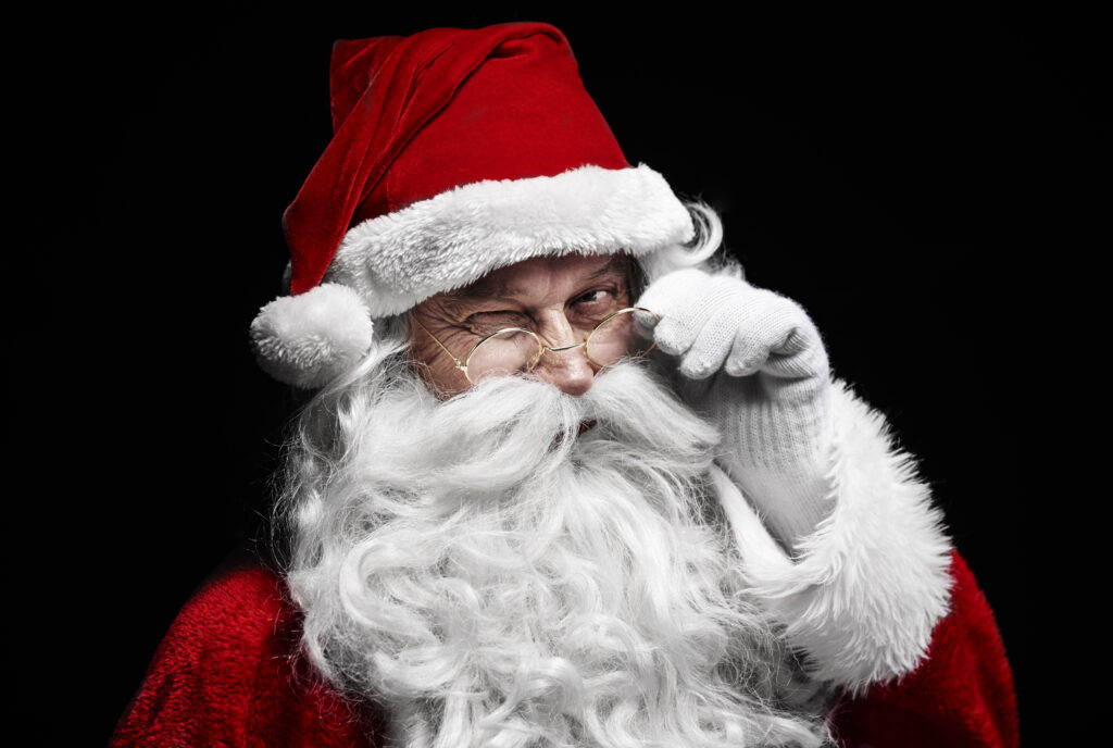 The Love Central - Man in santa claus costume winking The Love Central -