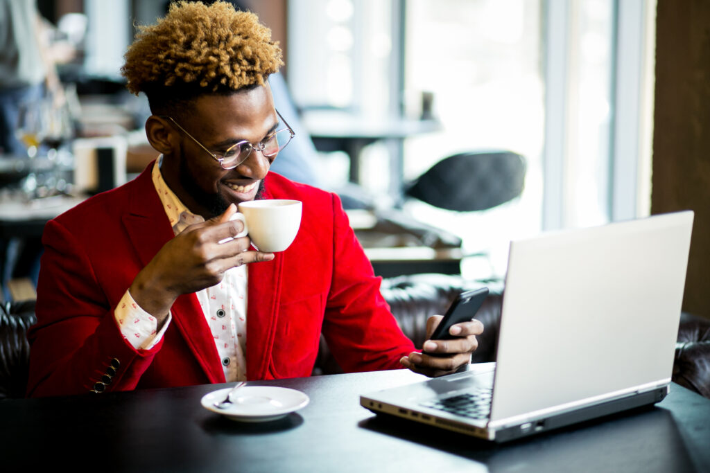The Love Central - African american man in a cafe 5 Side Hustles to Make Extra Money in 2024