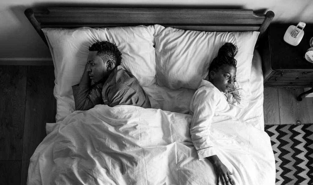 The Love Central - African American couple sleeping back to back The Love Central -
