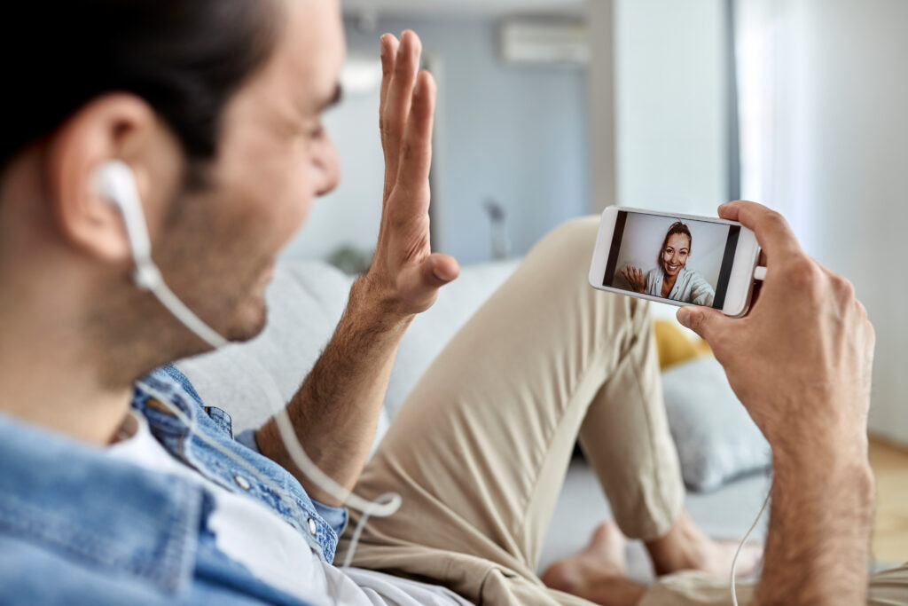 The Love Central - Close-up of a couple having video call over smart phone. The Love Central - 7 Social Media Features You Need To Navigate Long-Distance Relationships