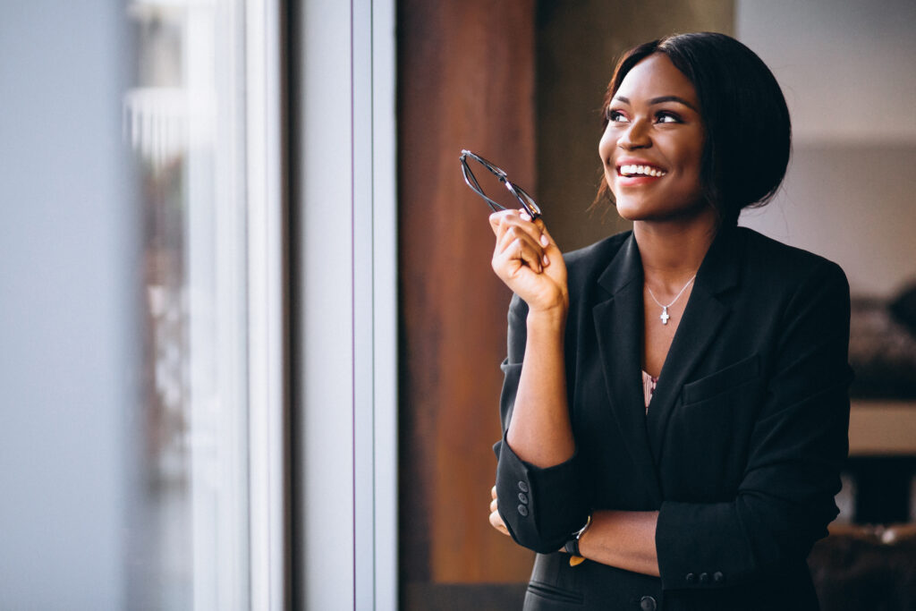 The Love Central - African american business woman by the window 5 Easy Steps to Learn New Skills and Tools for Your Side Hustle
