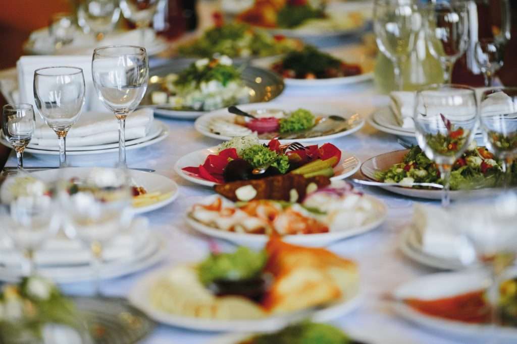 The Love Central - Plates with variety food on the celebration table The Love Central -