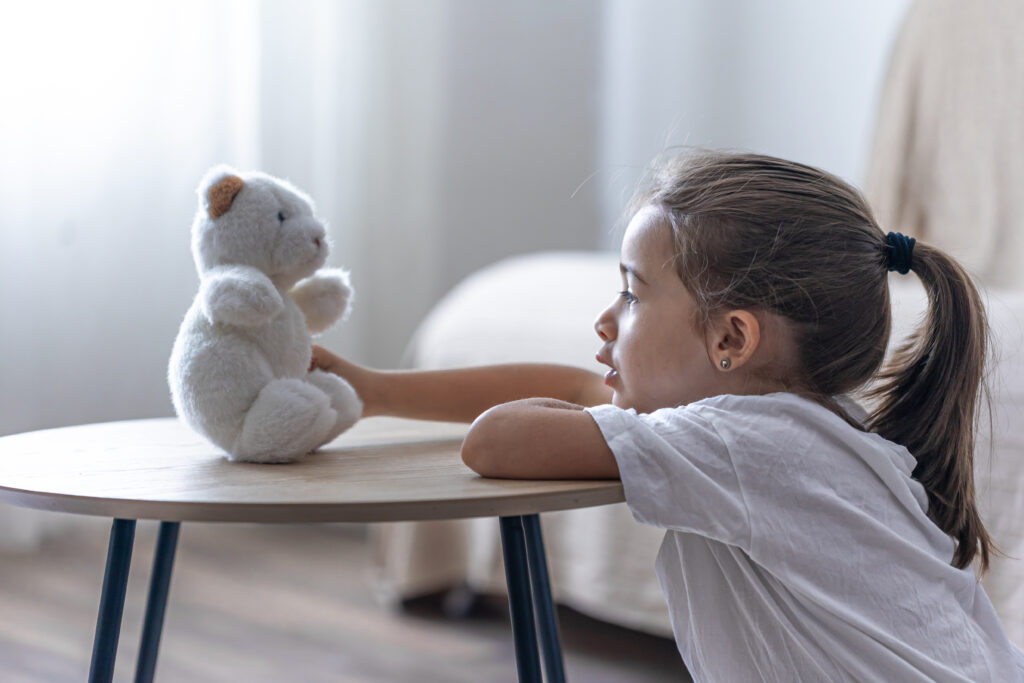 The Love Central - A little girl plays with her teddy bear. Don’t Worry, Mommy Will Be Back: How to Handle Separation Anxiety in Preschoolers