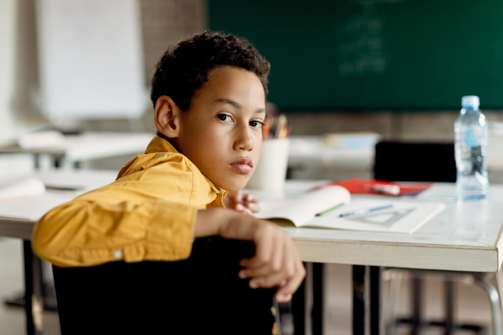 The Love Central - Black schoolboy turning to camera while sitting in the classroom Don’t Worry, Mommy Will Be Back: How to Handle Separation Anxiety in Preschoolers