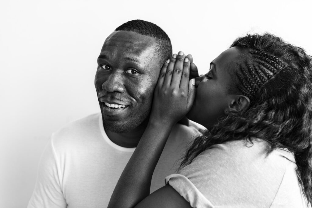 The Love Central - Couple whispering in the ear How to Use Body Language to Enhance Your Love Life