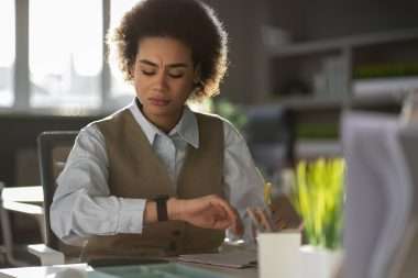A oman checking time on her wristwatch