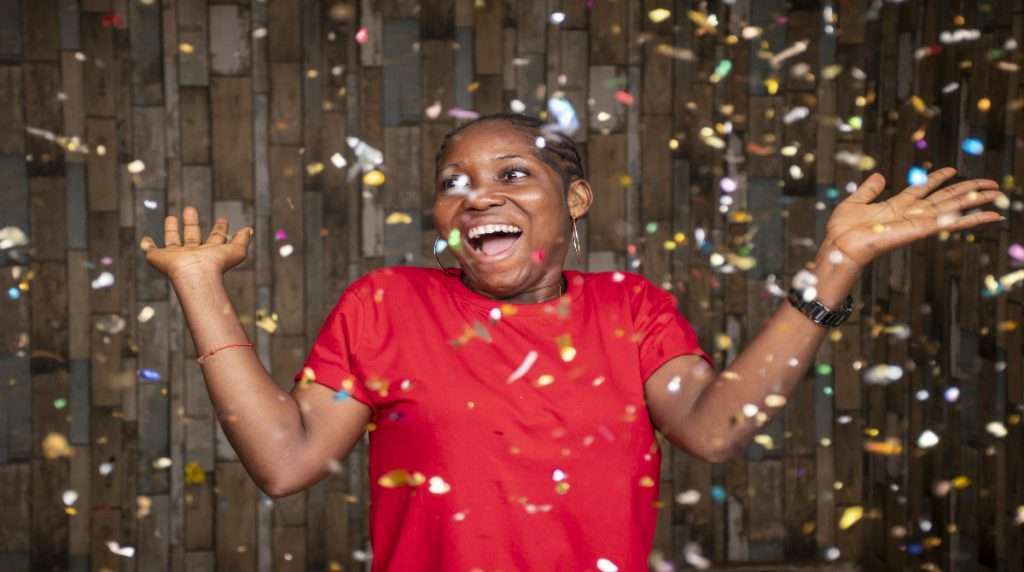 The Love Central - happy-woman-celebrating-with-confetti-front-wooden-wall-fotor-2024020419519 The Love Central -