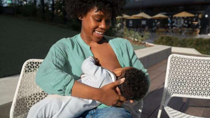 A smiling mother breastfeeding vher baby