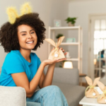 The Love Central - A smiling lady with wrapped Easter gifts