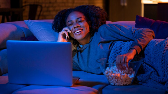 A lady making a call while watching a movie