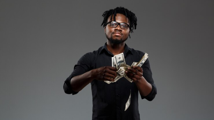 A black young man spraying money.