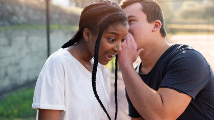 Couple whispering and gigling