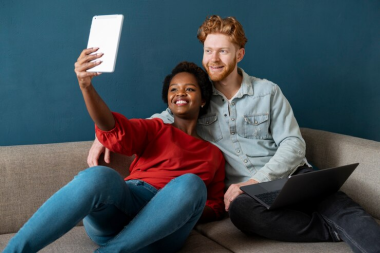 A couple similing and posing for the camera.