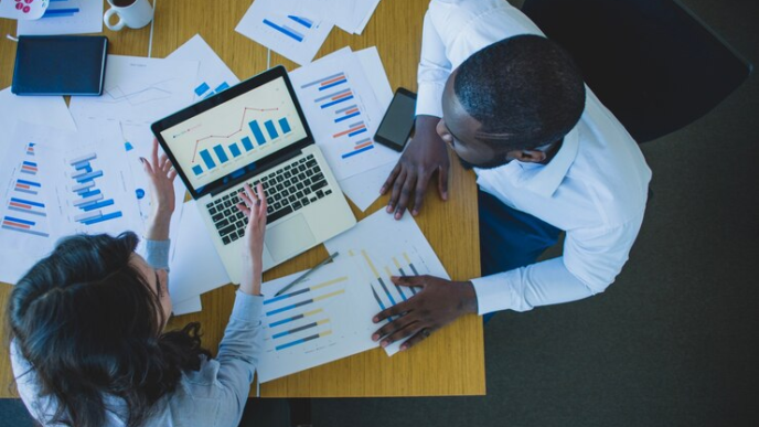 Two adults discussing investment strategies for their financial future.