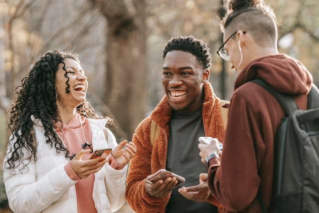 The Love Central - 3 friends together 3 friends laughing in a group. https://www.pexels.com/photo/laughing-diverse-friends-with-smartphones-in-park-6146961/