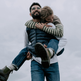 a dude giving a girl a piggy ride on his back