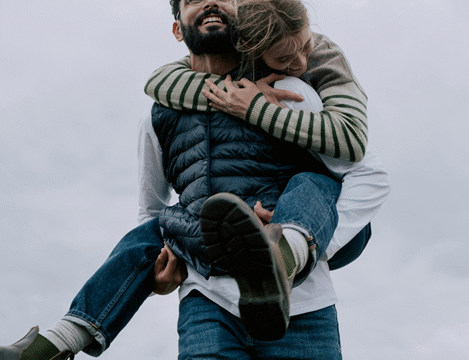 a dude giving a girl a piggy ride on his back