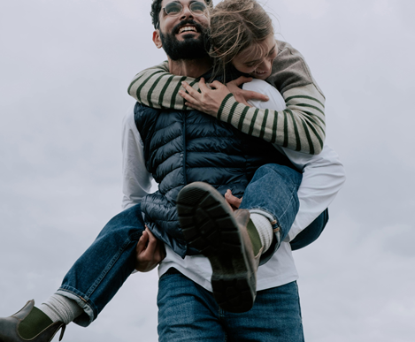 a dude giving a girl a piggy ride on his back