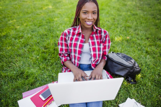 A beautiful African youth working on her laptop