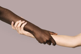 Diverse hands holding and supporting one another.