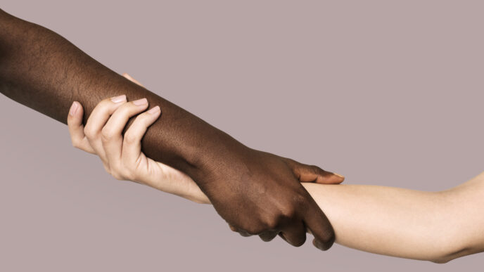 Diverse hands holding and supporting one another.