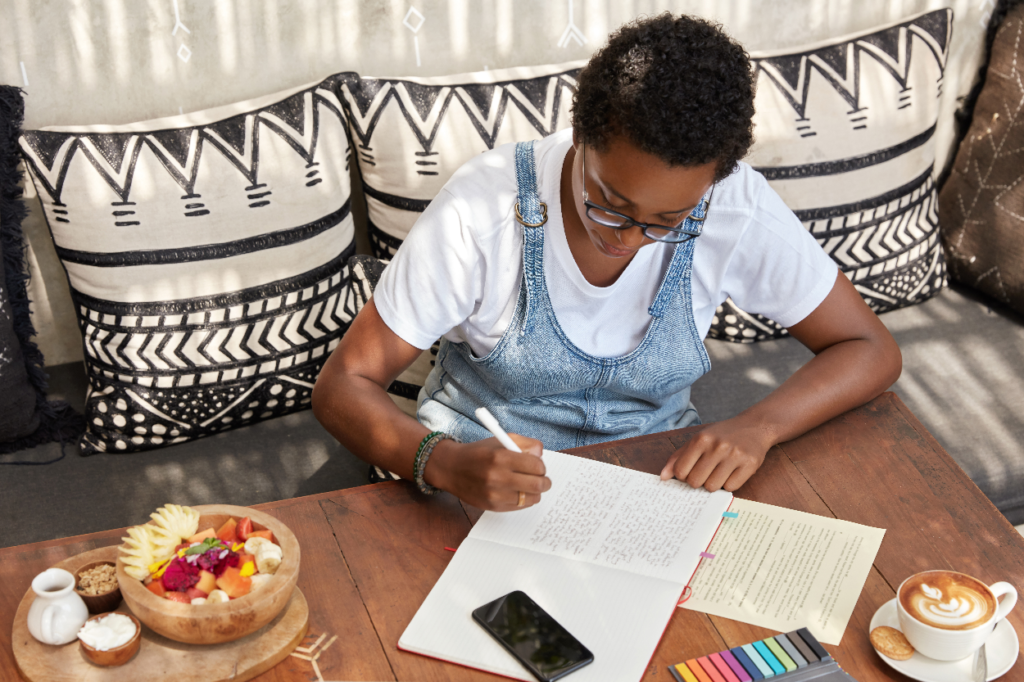 The Love Central - top-view-attractive-stylish-black-woman-writes-review-book-notepad The Love Central -