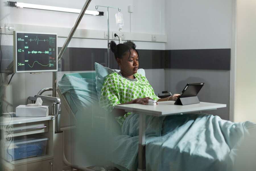 The Love Central - young-african-american-woman-using-tablet-hospital-ward-bed-sick-patient-with-online-technology-recovering-from-disease-clinic-with-medical-equipment-person-web-surfing_482257-16507 The Love Central -