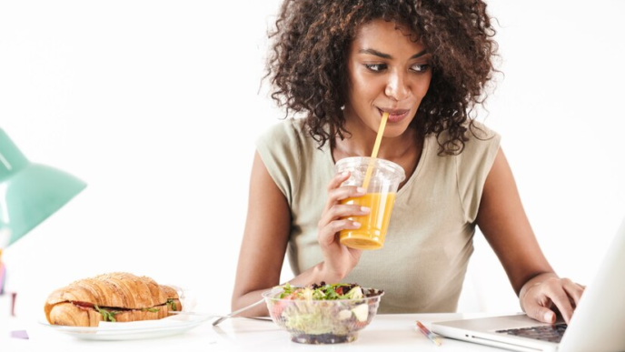A lady working with a breakfast set on her table.