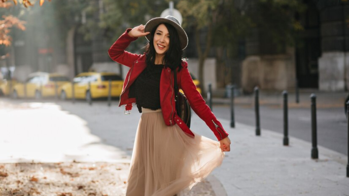 A pretty girl wearing a midi skirt and hat