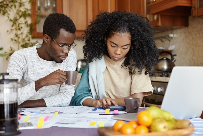 The Love Central - How to Create a Financial Safety Net for Your Family The Love Central - Black couple planning their finances.
