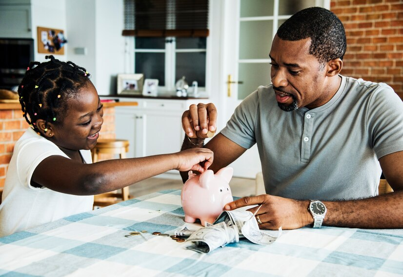 The Love Central - How to Create a Financial Safety Net for Your Family The Love Central - A father piggy saving with his daughter