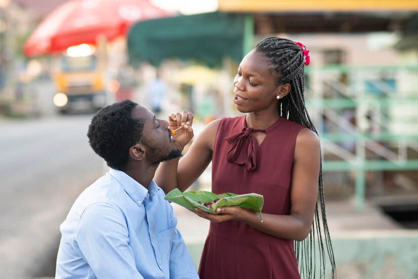 The Love Central - The Unique Challenges of Dating in Africa as a Returnee The Love Central - Lady feeding a guy
