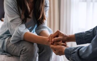 Couple holding hands and apologizing