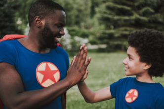 Father and son wearing a superhero atire