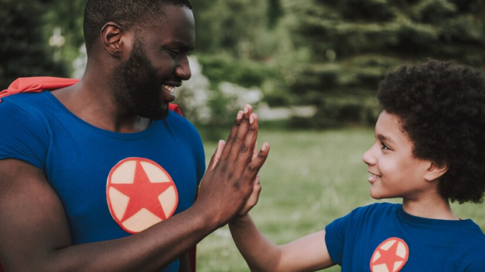 Father and son wearing a superhero atire