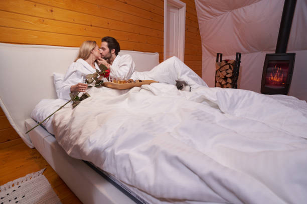 The Love Central - The Post-Holiday Bedroom Slump: Why It Happens and How to Fix It The Love Central - Couple kissing on the bed