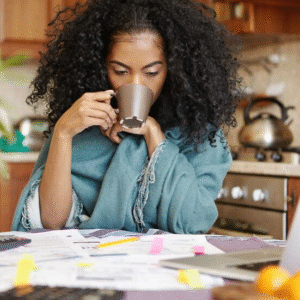 The Love Central - A lady calculating her finances while drinking coffee
